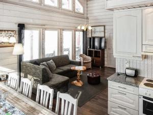 a living room with a couch and a table at Holiday Home Kerkänperä by Interhome in Luosto +21 photos