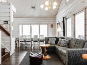 a living room with a couch and a table at Holiday Home Kerkänperä by Interhome in Luosto