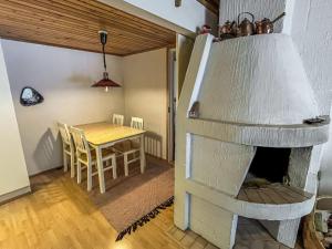 a kitchen and dining room with a stone fireplace at Holiday Home Ylläskakkonen b9 by Interhome in Ylläsjärvi +7 photos