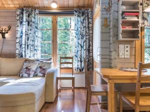 a living room with a bed and a table at Holiday Home Isonparit b3 by Interhome in Ylläsjärvi