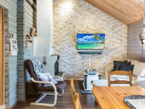 a living room with a tv on a brick wall at Holiday Home Isonparit b3 by Interhome in Ylläsjärvi