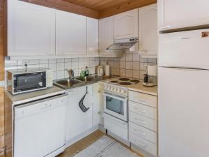 a kitchen with white appliances and a white refrigerator at Holiday Home Tunturinvieri k2 by Interhome in Ylläsjärvi