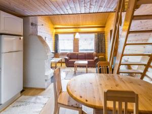a kitchen and living room with a table and a couch at Holiday Home Tunturinvieri k2 by Interhome in Ylläsjärvi