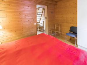 a bedroom with a bed and wooden walls at Holiday Home Tunturinvieri k2 by Interhome in Ylläsjärvi +8 photos