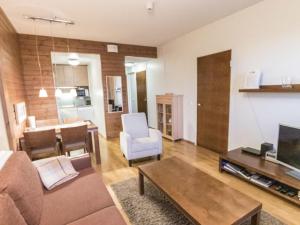 a living room with a couch and a table at Holiday Home Ylläs chalets a202 by Interhome in Ylläs
