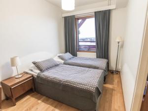 two beds in a small room with a window at Holiday Home Ylläs chalets a202 by Interhome in Ylläs