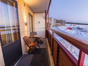 a balcony with two chairs and a table and a window at Holiday Home Ylläs chalets a202 by Interhome in Ylläs
