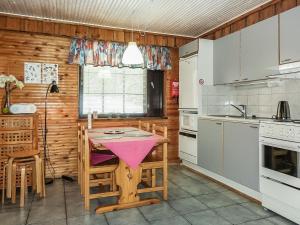 a kitchen with a table and chairs in a room at Holiday Home Kantapää c 3 by Interhome in Luosto