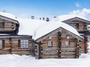 a log cabin with snow on the roof at Holiday Home Kantapää c 3 by Interhome in Luosto