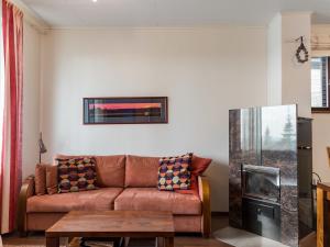 a living room with a couch and a fireplace at Holiday Home Villa ylläs 101 by Interhome in Ylläs