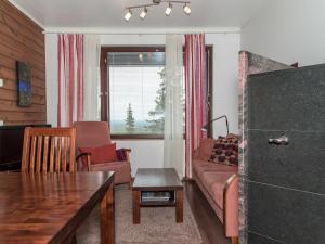 a living room with a couch and a table at Holiday Home Villa ylläs 101 by Interhome in Ylläs