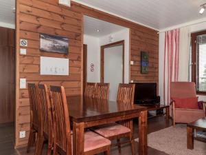 a dining room with a wooden table and chairs at Holiday Home Villa ylläs 101 by Interhome in Ylläs +12 photos