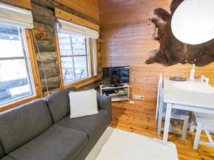 a living room with a couch and a table at Holiday Home Ylläsrova b5 - kasku by Interhome in Ylläsjärvi
