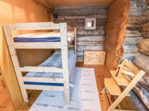 a bedroom with two bunk beds in a log cabin at Holiday Home Ylläsrova b5 - kasku by Interhome in Ylläsjärvi