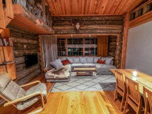 a living room with a couch in a log cabin at Holiday Home Karkelo by Interhome in Ylläsjärvi