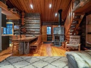a dining room with a table and a wood stove at Holiday Home Karkelo by Interhome in Ylläsjärvi +19 photos