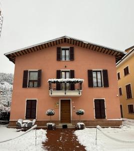 a large house with a balcony in the snow at Sibilla Ospitalità in Visso