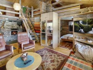 a log cabin living room with a fireplace at Holiday Home Hankisääski by Interhome in Ylläsjärvi