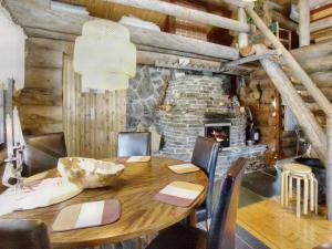 a dining room with a table and a fireplace at Holiday Home Hankisääski by Interhome in Ylläsjärvi