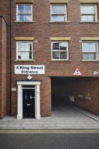 a brick building with a king street entrance at The Distillery Room in Scarborough +2 photos