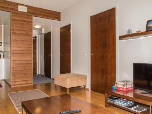 a living room with a television and a table at Holiday Home Ylläs chalets a402 by Interhome in Ylläs