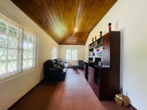 a living room with a couch and a wooden ceiling at Herondale Estate Bunglow in Nawalapitiya