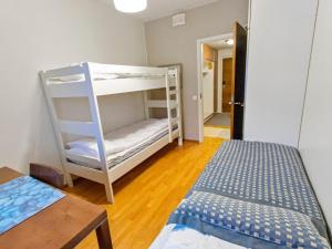 a room with two bunk beds and a bed at Holiday Home Ylläs chalets a508 by Interhome in Ylläs +12 photos