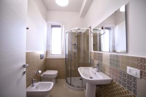 a bathroom with a sink and a toilet and a mirror at Home Scala dei Turchi B&B in Realmonte +37 photos