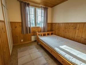 a bedroom with a bed and a window at Holiday Home Meritähti by Interhome in Matildedal
