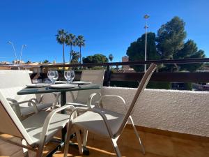 a patio table and chairs on a balcony at Apartment with private balcony in San Javier