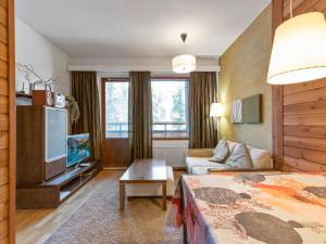 a hotel room with a bed and a tv at Holiday Home Ylläs chalets 2405 by Interhome in Ylläs