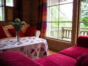 a living room with a table with a vase on it at Holiday Home Pernoo 1 by Interhome in Pernoo