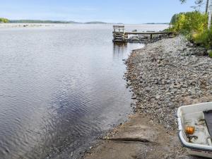 a boat on the shore of a body of water at Holiday Home Mäntylä by Interhome in Nurmes