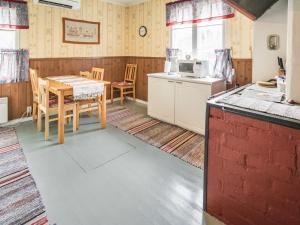 a kitchen and dining room with a table and chairs at Holiday Home Mäkitupa by Interhome in Laiterla
