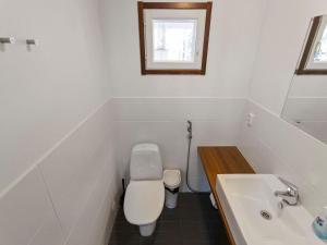 a white bathroom with a toilet and a sink at Holiday Home Halla by Interhome in Levi +9 photos