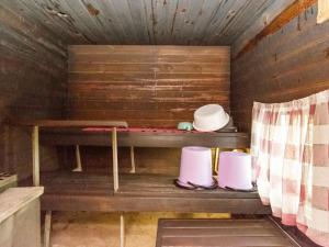 a small room with a shelf with hats on it at Holiday Home 21 by Interhome in Varparanta