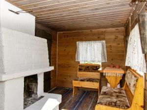 an interior of a log cabin with a fireplace at Holiday Home 21 by Interhome in Varparanta