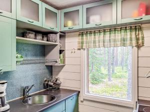 a kitchen with a sink and a window at Holiday Home Pilkkaniemi by Interhome in Rontsa