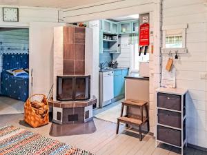 a kitchen with a stove in the middle of a room at Holiday Home Pilkkaniemi by Interhome in Rontsa +32 photos