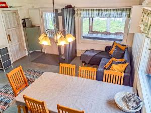 a living room with a table and chairs and a couch at Holiday Home Pilkkaniemi by Interhome in Rontsa