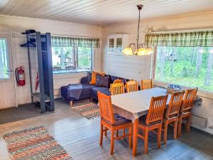 a living room with a table and chairs and a couch at Holiday Home Pilkkaniemi by Interhome in Rontsa