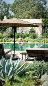 a couple of people in a swimming pool at Maison Flamingo - Boutique hôtel in Essaouira