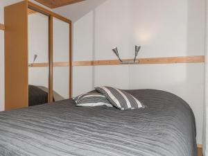 a bedroom with a bed with a pillow and a mirror at Holiday Home Ylläs-eeli green house c2 by Interhome in Ylläsjärvi +15 photos