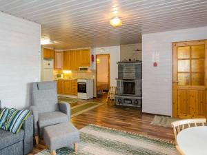a living room with a couch and a chair at Holiday Home Lomaranta by Interhome in Ruvaslahti