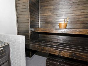 a wooden wall with a bench in a kitchen at Holiday Home Lomaranta by Interhome in Ruvaslahti +17 photos