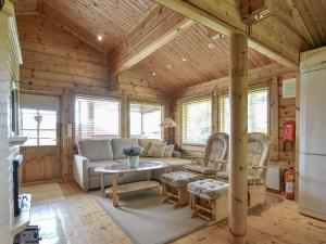 a living room with a couch and a table at Holiday Home Kannelpirtti 1 by Interhome in Puromäki