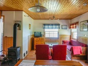 a living room with a couch and a stove at Holiday Home Rantasipi 1 by Interhome in Strandby +2 photos