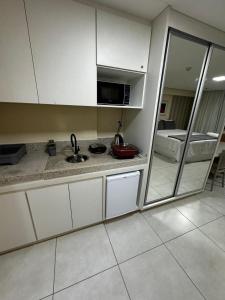 a kitchen with a sink and a microwave at Flat no Vivence Suites em Palmas in Palmas +3 photos