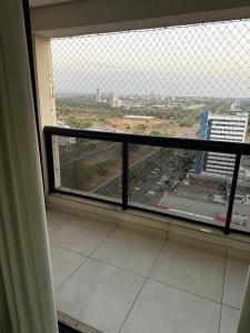 a window in a building with a view of a city at Flat no Vivence Suites em Palmas in Palmas