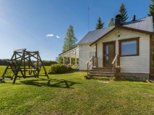 a house with a playground and a swing at Holiday Home Tarvas by Interhome in Tarvaspohja +24 photos